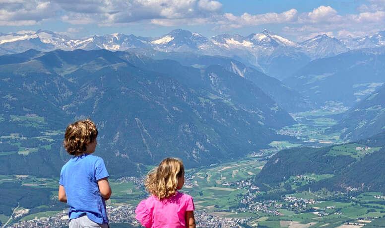 Children overlooking mountains during hike