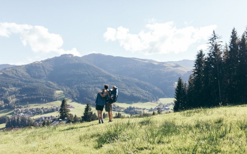 a couple with a toddler in backpack walking