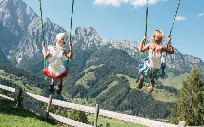 Children on a swing at the Austrian Boutique Hotel & Apartments