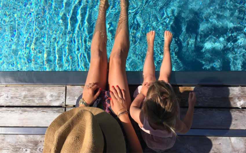 Feet dangling in the swimming pool Feet dangling in the swimming pool