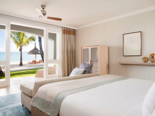Big bed in hotel room with beach view