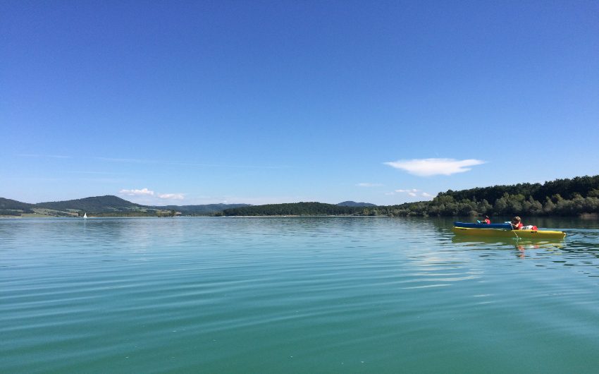 Blue lake with small boat