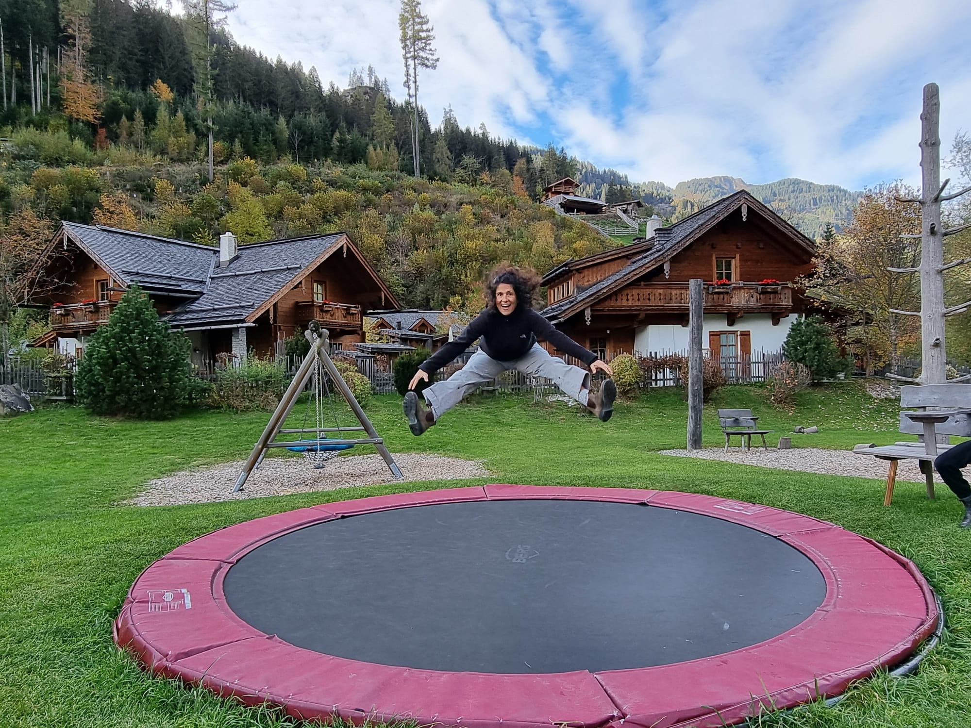 Girl jumping on trampoline at the Austrian Countryside Chalets