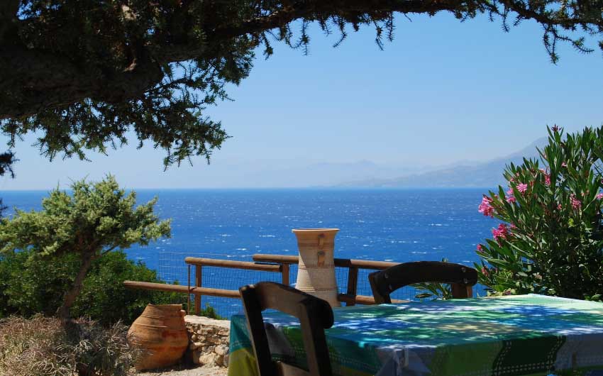 View of Crete's coastline from a table with The Little Voyager