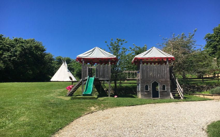 Girl climbing playhouse at French Hamlet