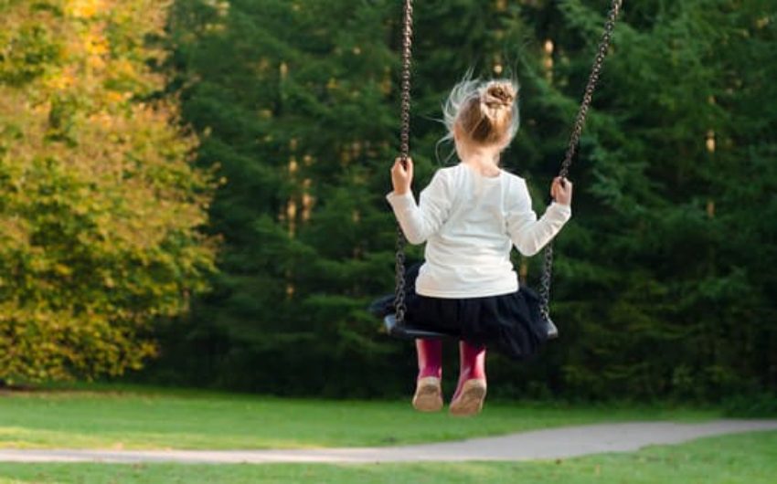 Girl on swing at The Sussex Cottages