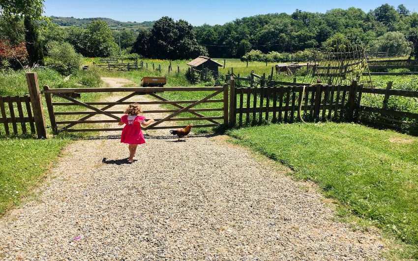 Girl walking towards fence at French Hamlet