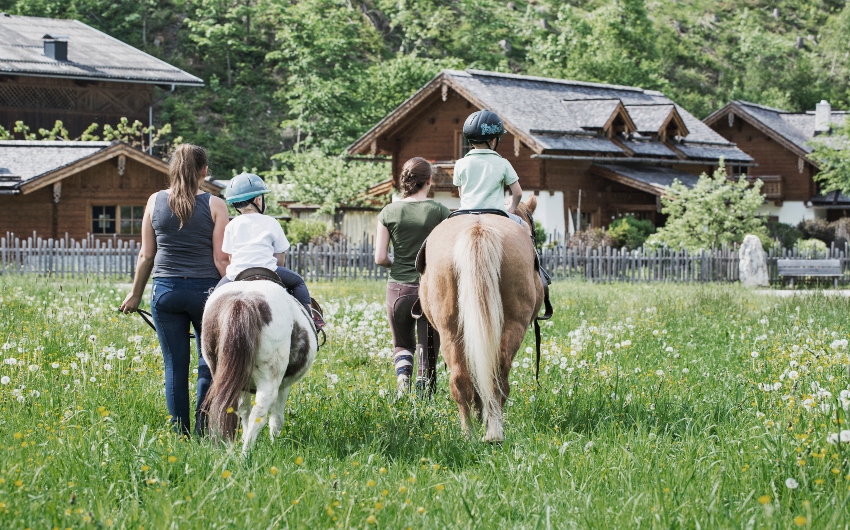 Children riding horses at the Austrian Countryside Chalets