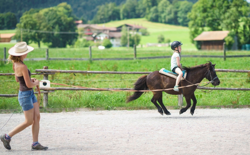 Boy horseback riding at the Bavarian Farm