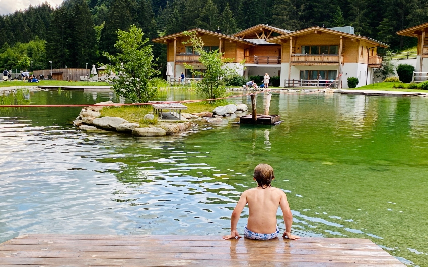 Boy in natural lake at the South Tyrolean Nature Resort