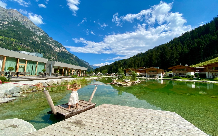 Girl on natural lake at the South Tyrolean Nature Resort