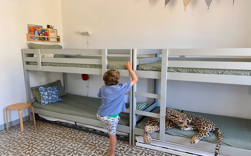 Boy climbing bunkbed t the Costa Brava Beach Apartment