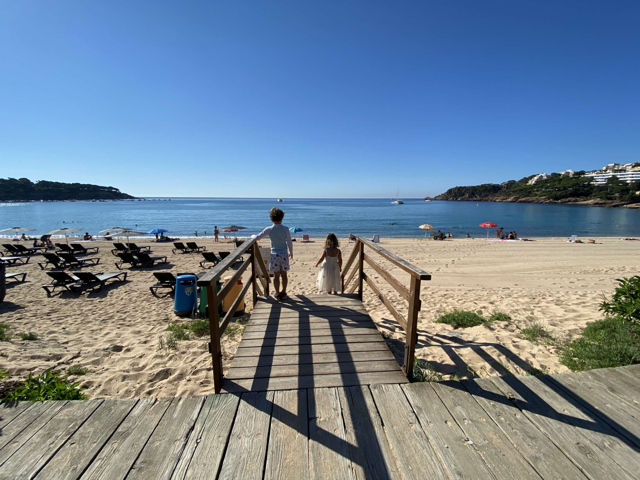 Kids looking at the sea on a beach at the Costa Brava