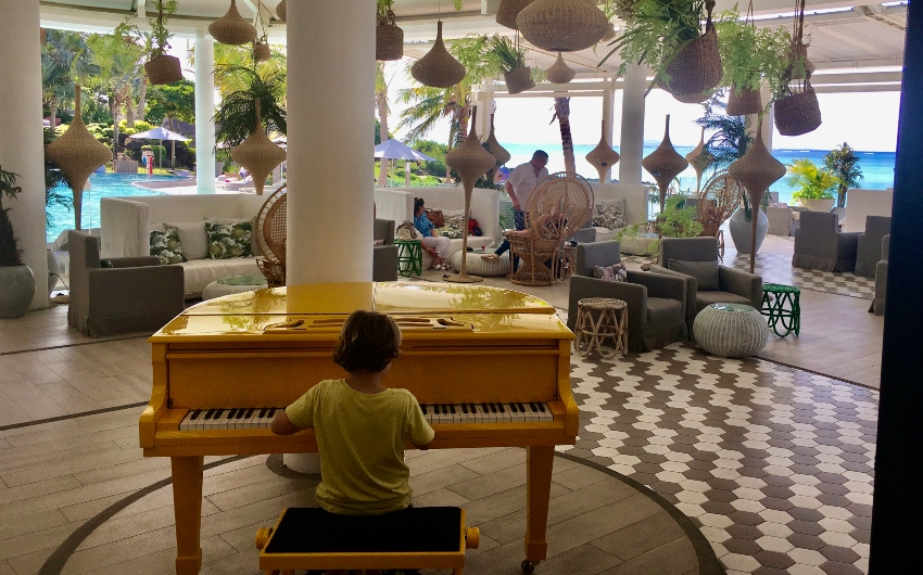 boy playing piano at LUX* Grand Gaube