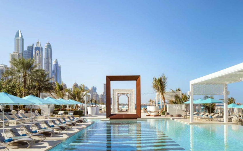 Pool with Dubai skyline in the back at One&Only Roya Mirage