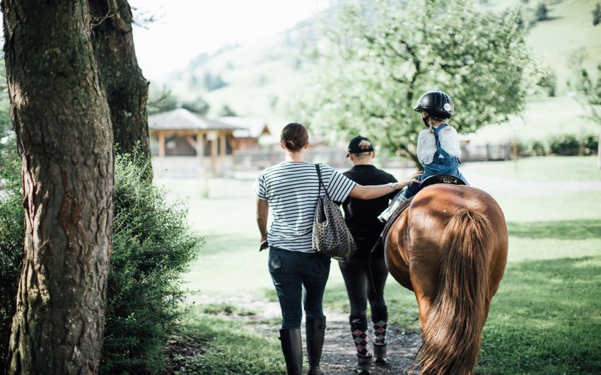 Kid riding a horse at the Austrian Nature Retreat