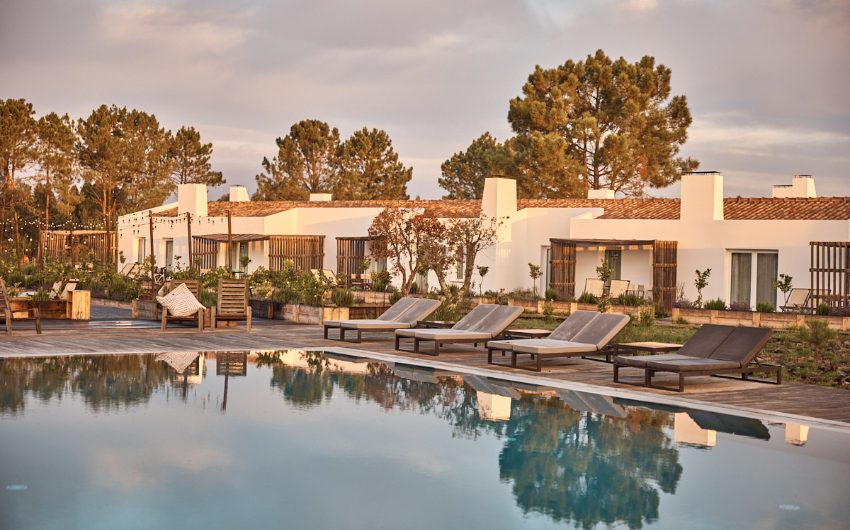 farmhouse apartments surrounding a pool and outdoor living area