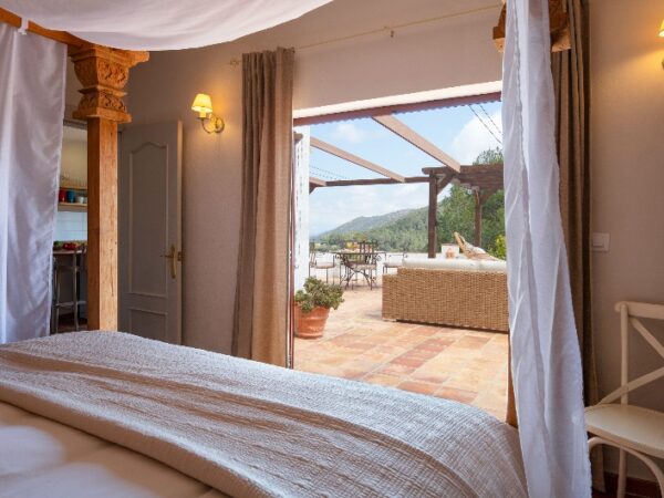 double bed looking out onto a Mediterranean terrace