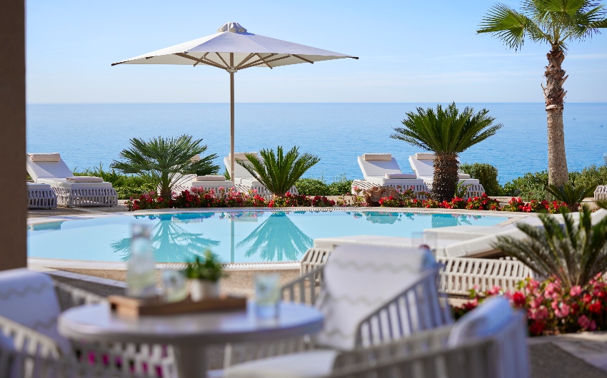 Restaurant with pool view at Ikos Oceania