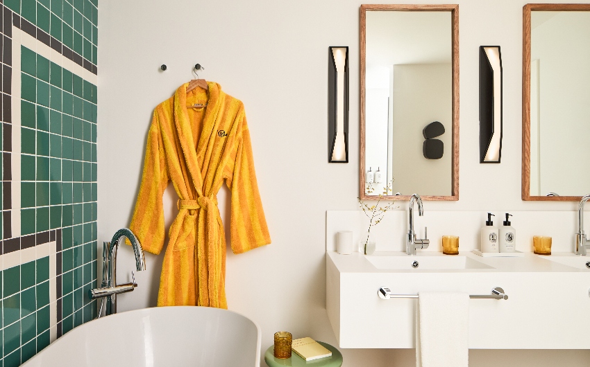Bathroom with yellow bathrobe at Kimpton Los Monteros Marbella